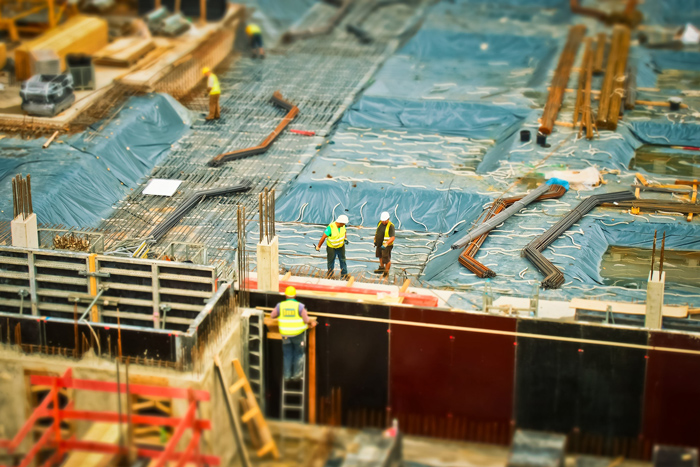 Workers in high-vis vests on a building site